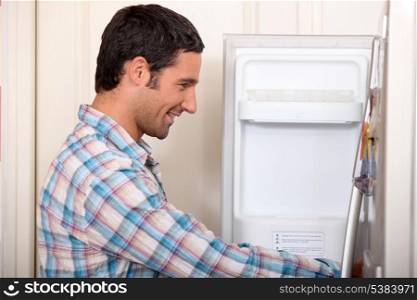 Man opening fridge door