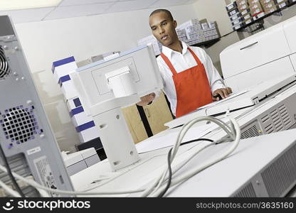 Man operating printing machine at press