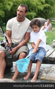 Man out fishing with his son