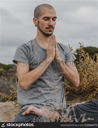 man outdoors doing yoga