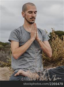 man outdoors doing yoga