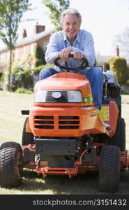 Man outdoors on lawnmower smiling