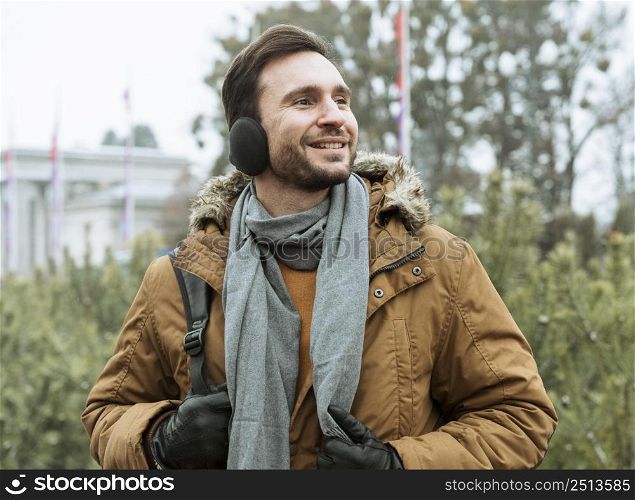 man outdoors winter wearing ear muffs