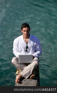 Man outdoors with laptop