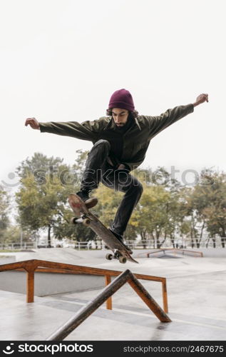 man outside with skateboard city park