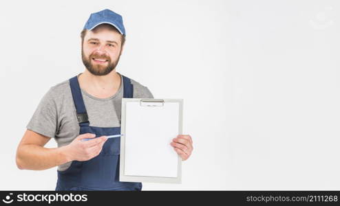 man overall showing clipboard with paper