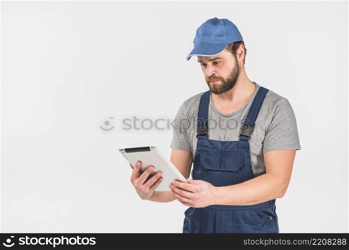 man overall using tablet