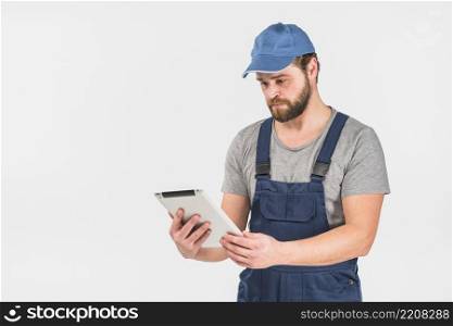 man overall using tablet