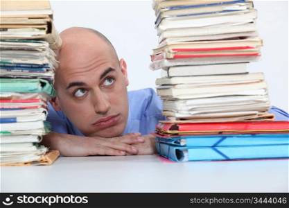 man overwhelmed with folders