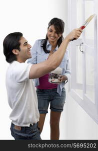 Man painting a window