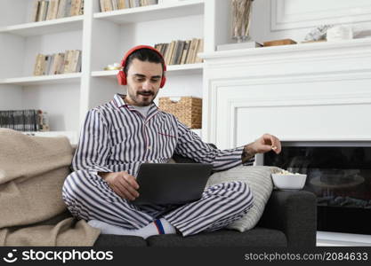 man pajamas spending fun time laptop