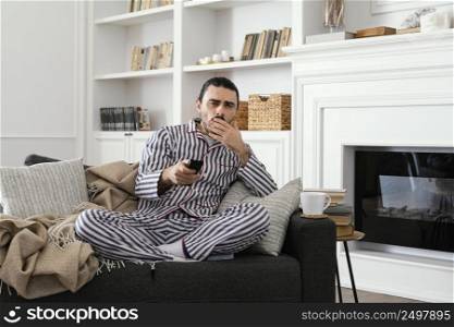 man pajamas watching tv front view
