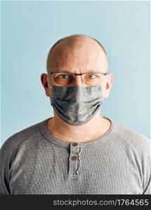 Man patient with face mask. Wearing coronavirus covid-19 protection medical mask during the pandemic