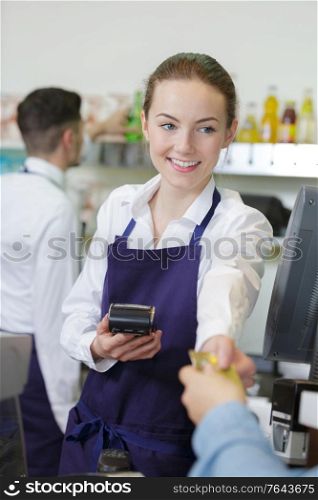 man paying bill at cafe using card