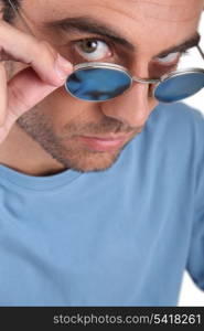 Man peering over his sunglasses