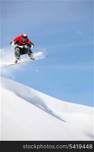 Man performing jump on snowboard