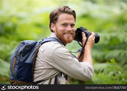 man photographer holding dslr camera