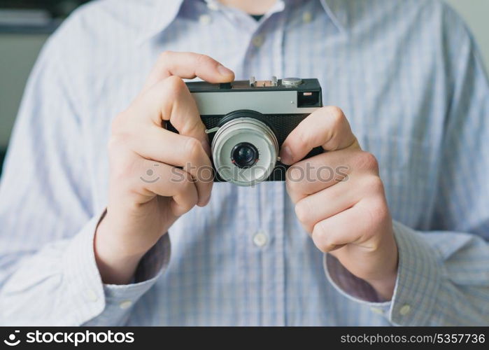 Man photographs on film camera