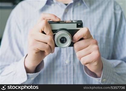 Man photographs on film camera