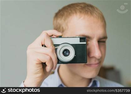 Man photographs on film camera
