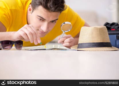 Man planning his vacation trip with map