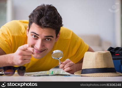 Man planning his vacation trip with map