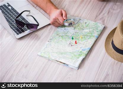 Man planning his vacation trip with map