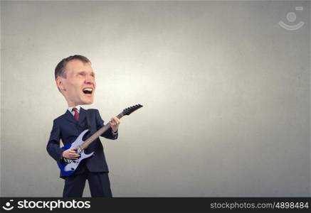 Man play guitar. Young businessman in suit with big head playing guitar
