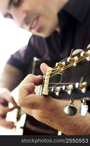 Man playing a musical instrument accoustic guitar