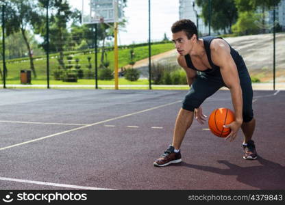 man playing basketball park court