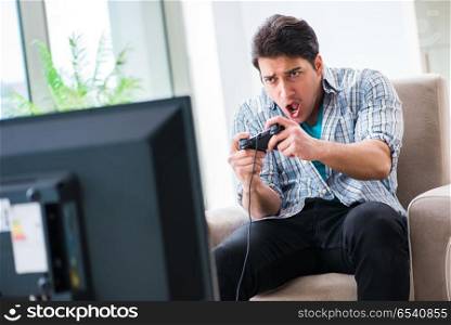 Man playing computer game at home