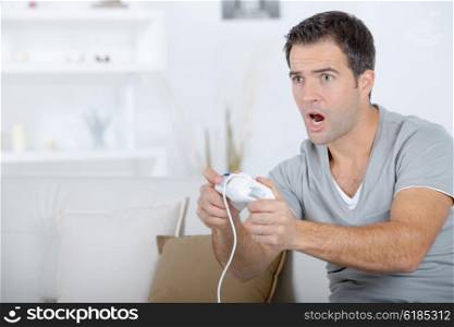 Man playing computer game, excited