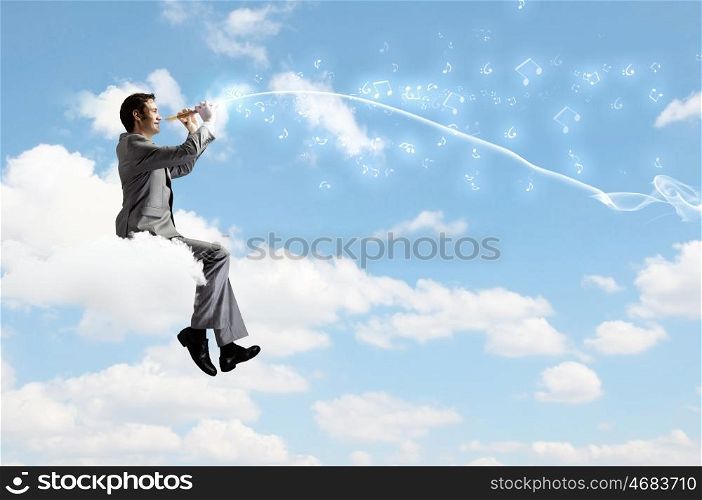 Man playing flute. Young carefree businessman sitting on cloud and playing flute