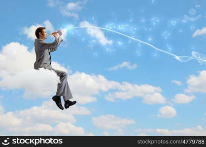 Man playing flute. Young carefree businessman sitting on cloud and playing flute