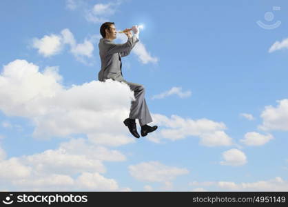 Man playing flute. Young carefree businessman sitting on cloud and playing flute