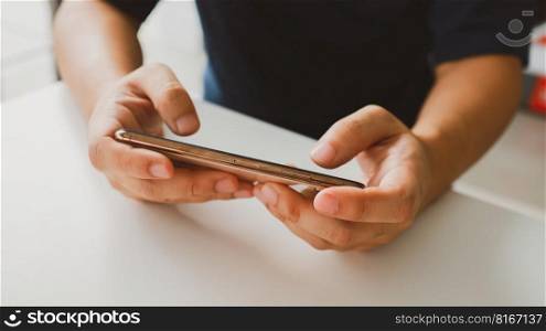 Man playing game on mobile phone. gamer boy playing video games holding Smartphone working mobile devices. cell telephone technology e-commerce concept.