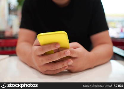 Man playing game on mobile phone. gamer boy playing video games holding Smartphone working mobile devices. cell telephone technology e-commerce 