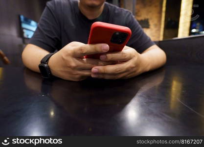 Man playing game on mobile phone. gamer boy playing video games holding Smartphone working mobile devices. cell telephone technology e-commerce concept