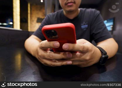 Man playing game on mobile phone. gamer boy playing video games holding Smartphone working mobile devices. cell telephone technology e-commerce concept