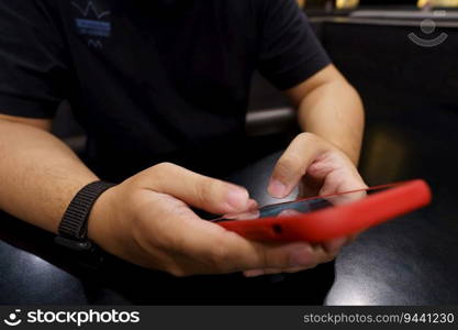 Man playing game on mobile phone. gamer boy playing video games holding Smartphone working mobile devices. cell telephone technology e-commerce concept