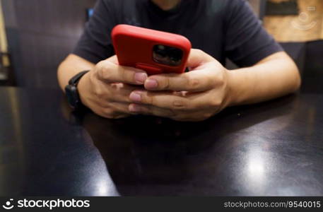 Man playing game on mobile phone. gamer boy playing video games holding Smartphone working mobile devices. cell telephone technology e-commerce concept