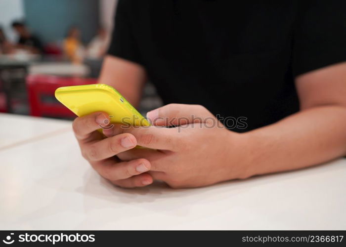 Man playing game on mobile phone. gamer boy playing video games holding Smartphoneworking mobile devices. cell telephone technology e-commerce