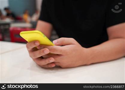 Man playing game on mobile phone. gamer boy playing video games holding Smartphoneworking mobile devices. cell telephone technology e-commerce