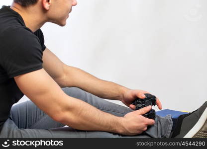 man playing games. a young man with black tshirt playing games in a game console computer