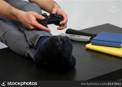 man playing games. a young man with black tshirt playing games in a game console computer