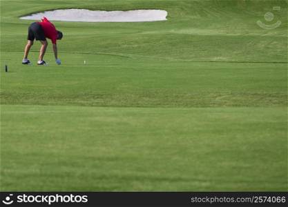 Man playing golf in a golf course