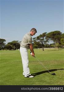 Man playing golf on golf course
