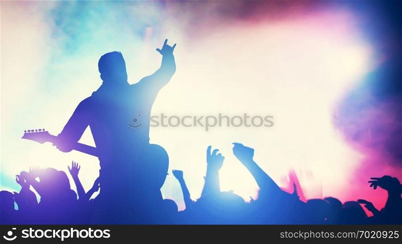 Man playing guitar at the stage, crowd cheering. Concert, music gig. Audience, fans, fame, entertainment. 3D illustration.. Man playing guitar at the stage, crowd cheering.