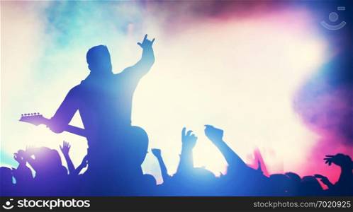 Man playing guitar at the stage, crowd cheering. Concert, music gig. Audience, fans, fame, entertainment. 3D illustration.. Man playing guitar at the stage, crowd cheering.