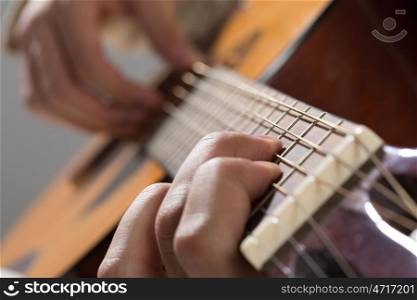 Man playing guitar. Close up of male hands playing acoustic guitar
